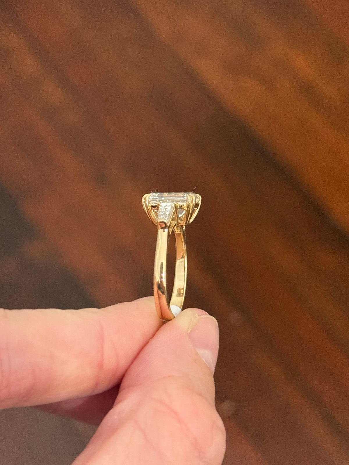 Yellow gold IGI certified emerald cut and tapered baguette lab diamond ring. Center stone is 3.03cts