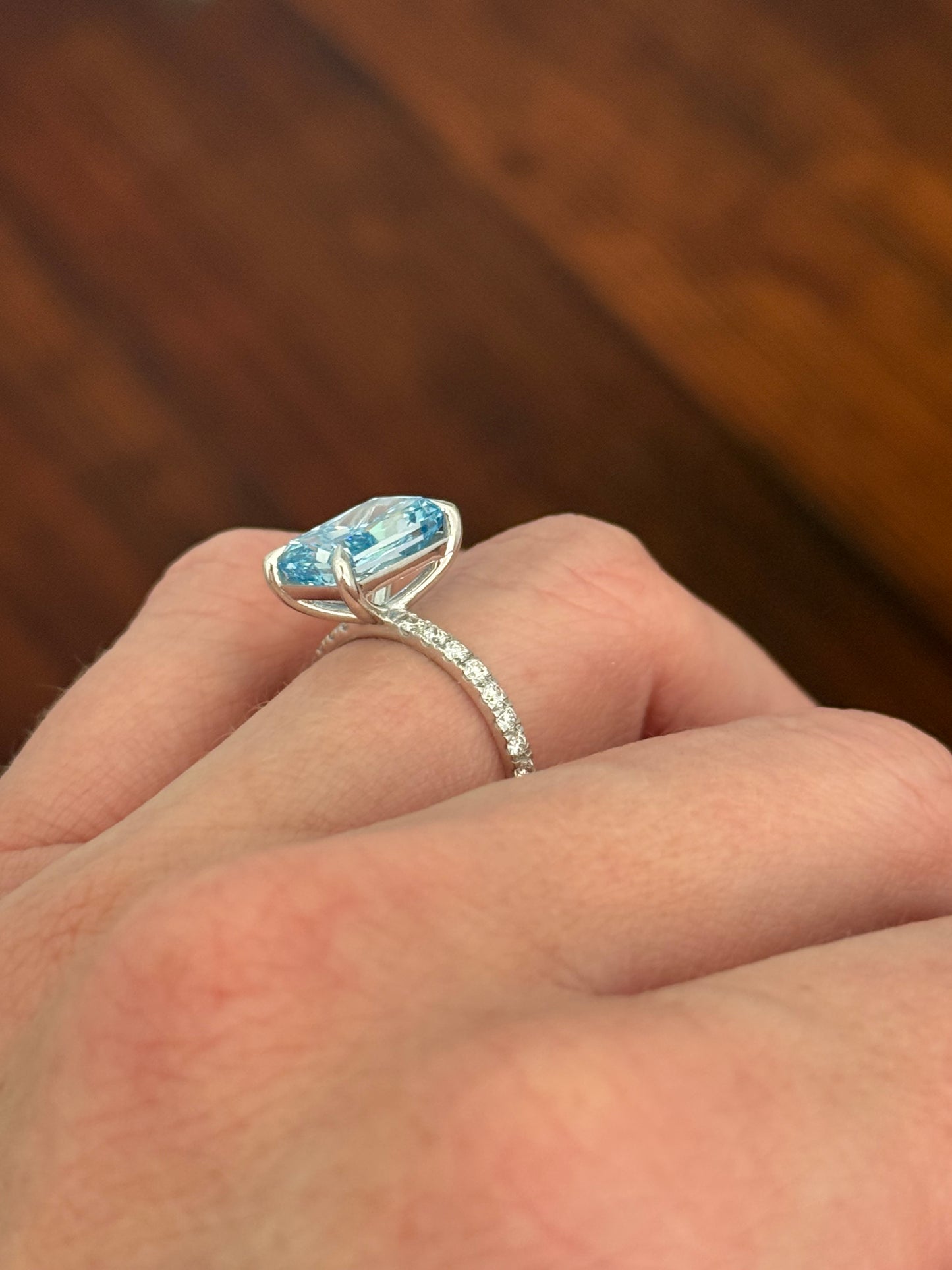 White gold radiant blue lab diamond and white lab diamond ring