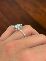 White gold radiant blue lab diamond and white lab diamond ring