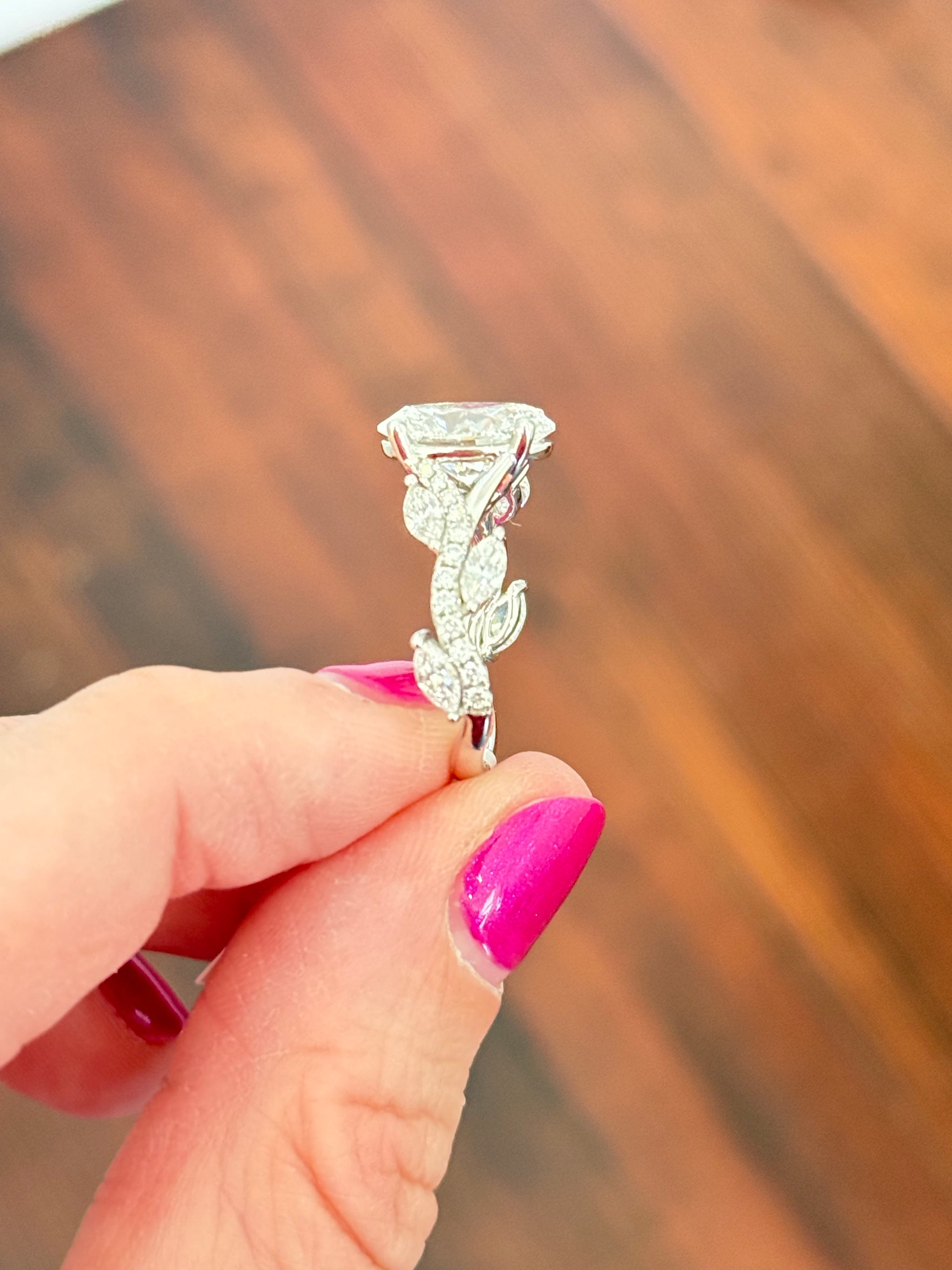 White gold oval, marquise and round lab diamond ring. Center stone is 3.07cts