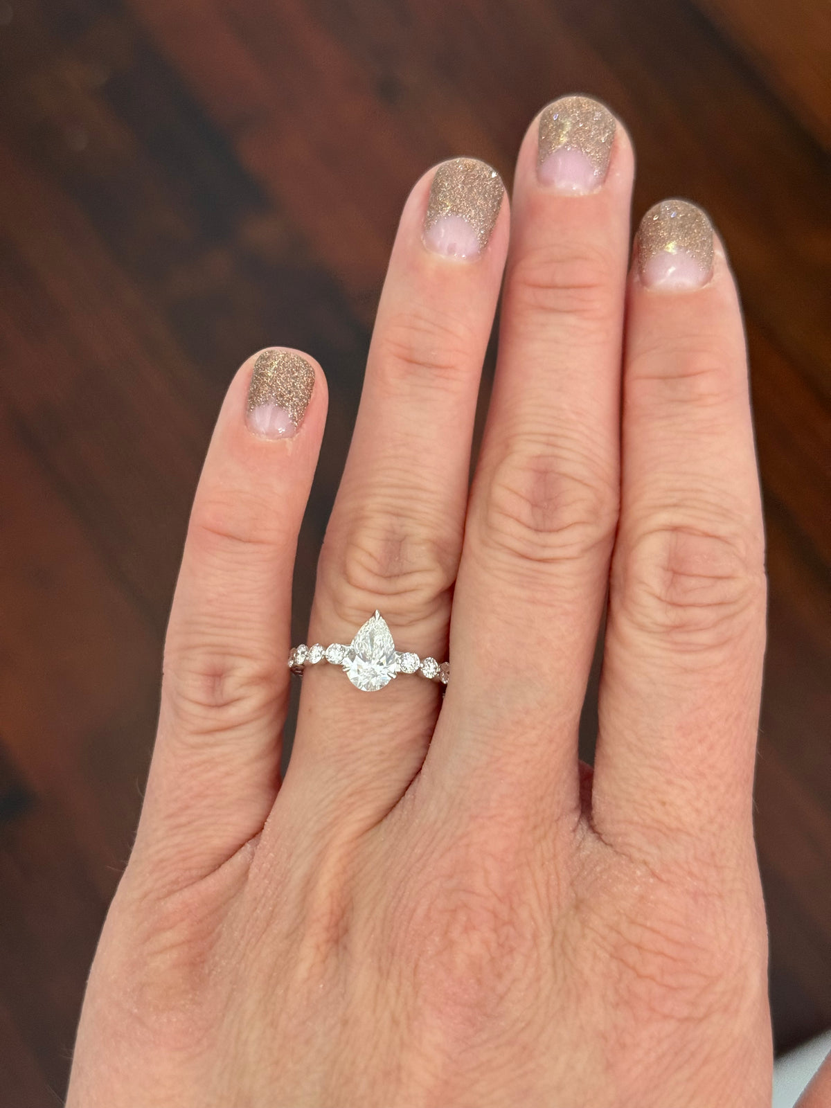 White gold pear shape and round lab diamond ring. Center stone is 1ct and approximately 9x5.3mm