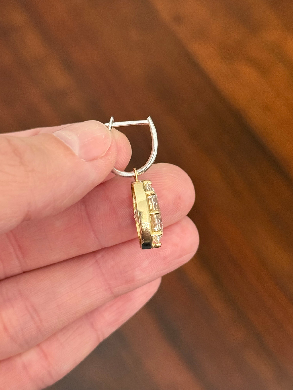 Oval lab diamond latch back earrings. Lab diamonds are set in yellow gold and earrings are white gold.