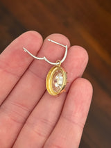 Oval lab diamond latch back earrings. Lab diamonds are set in yellow gold and earrings are white gold.