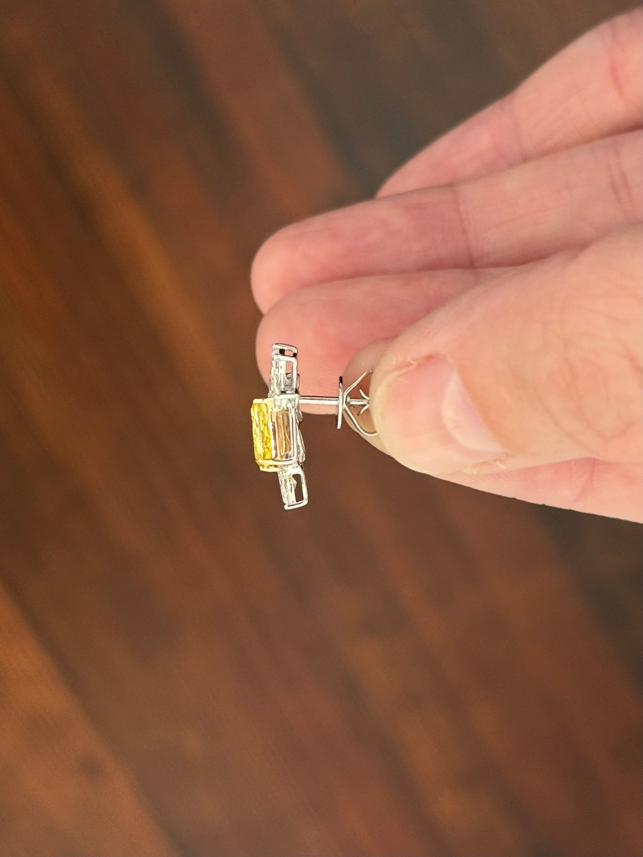 White gold radiant yellow lab diamond and pear shape and marquise white lab diamond earrings. Yellow lab diamond is set in yellow gold.