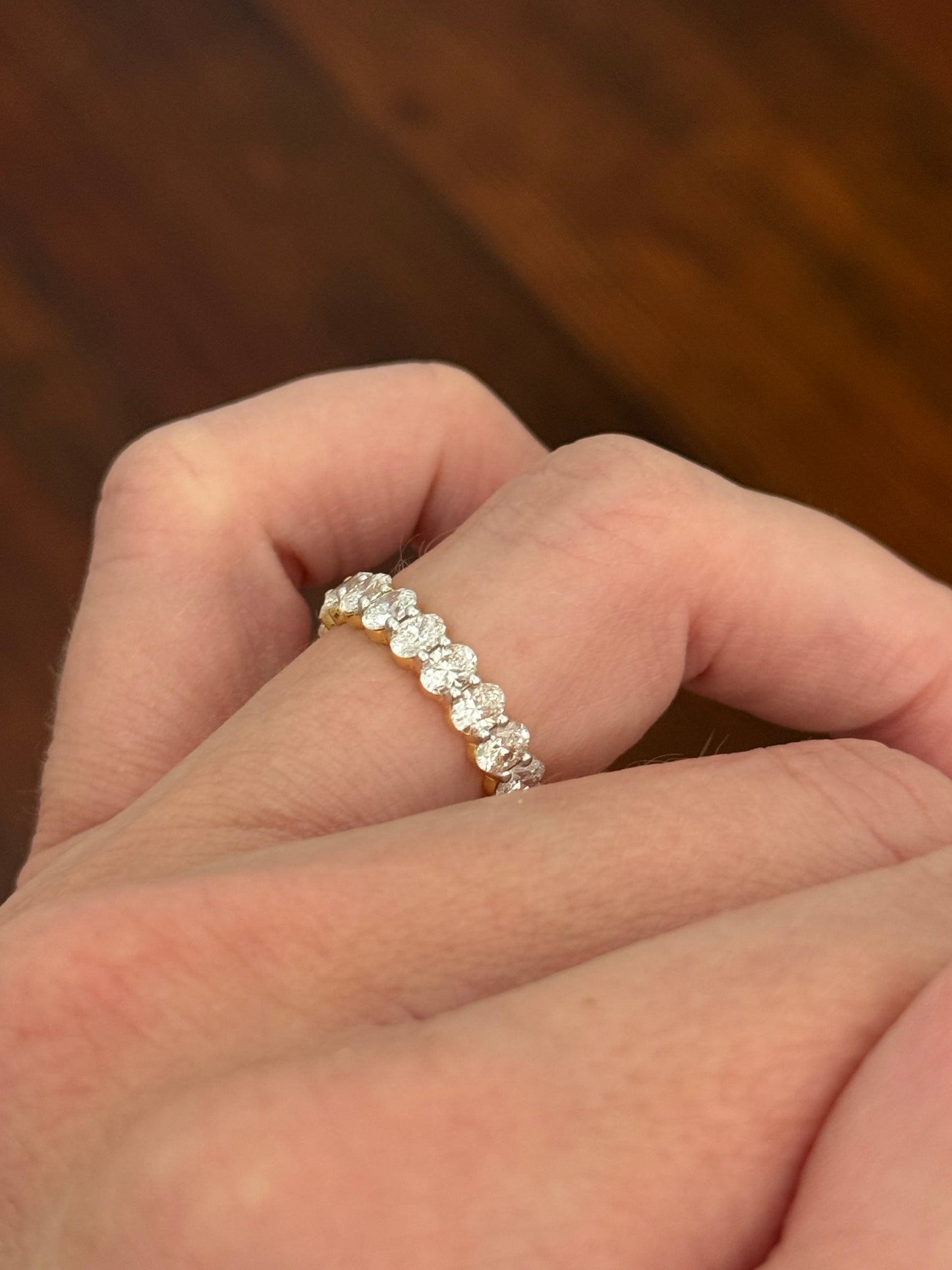 Yellow gold 3.02ct oval lab diamond eternity band. Prongs are white gold.