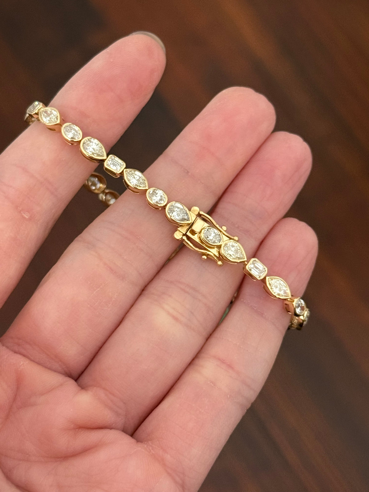 Yellow gold bezel set 7.58ct marquise, oval, emerald cut and pear shape natural diamond bracelet