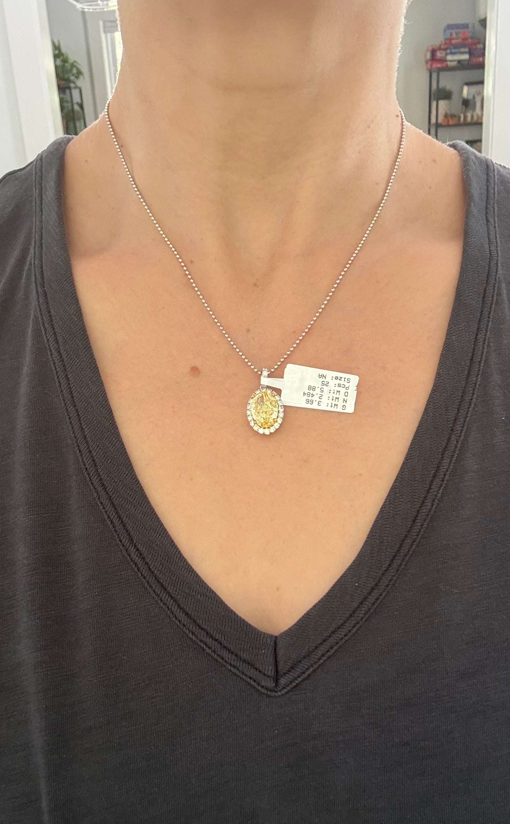 White gold oval yellow lab diamond and white round lab diamond pendant. Yellow lab diamond has yellow gold prongs and is IGI certified 5.11cts fancy vivid yellow VS2