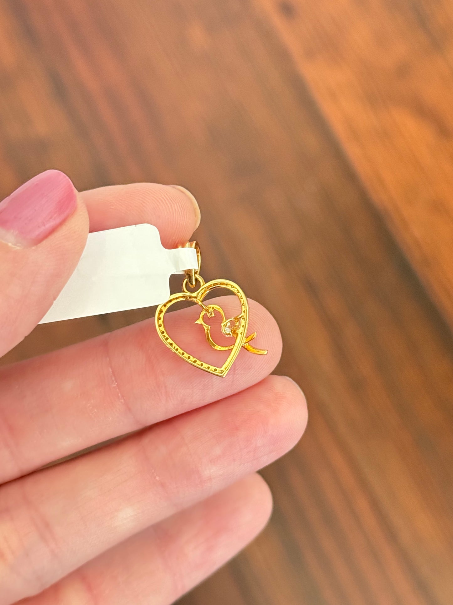 Yellow gold heart and bird pendant with pear shape and round lab diamonds