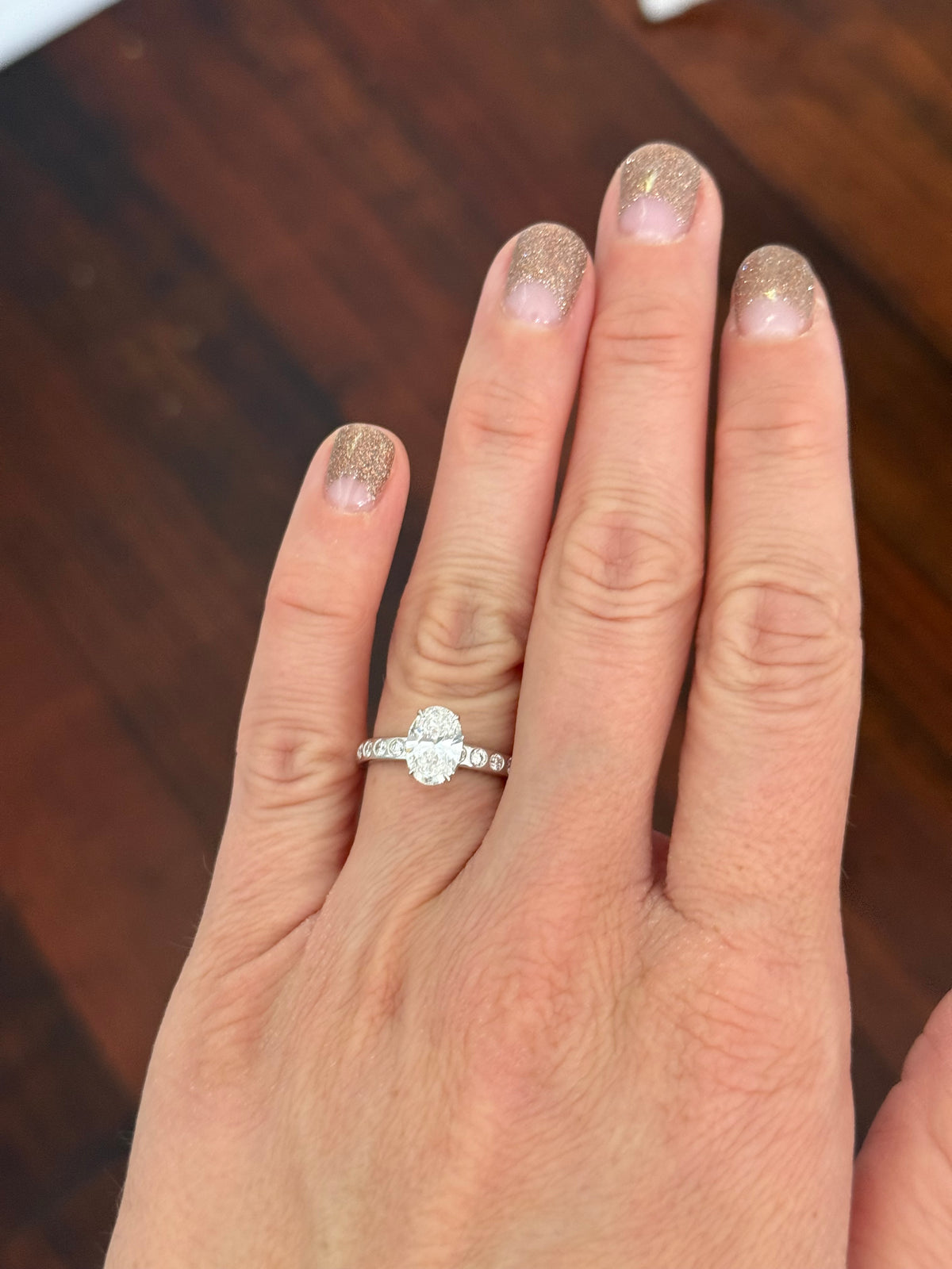 White gold oval and round lab diamond ring. Center stone is 1ct and 8.5x6mm