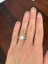 White gold oval and round lab diamond ring. Center stone is 1ct and 8.5x6mm