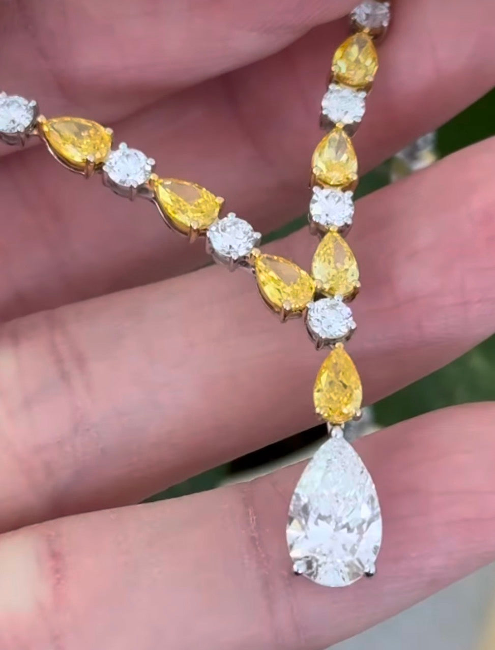 White gold pear shape yellow and white lab diamond and round white lab diamond necklace. Center stone is IGI certified and 1.86cts D VVS2