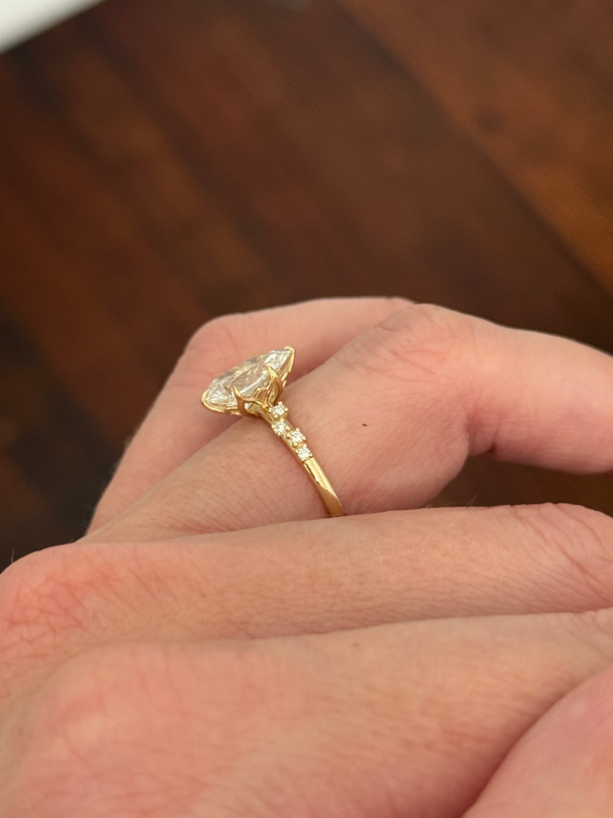 Yellow gold pear shape and round lab diamond ring