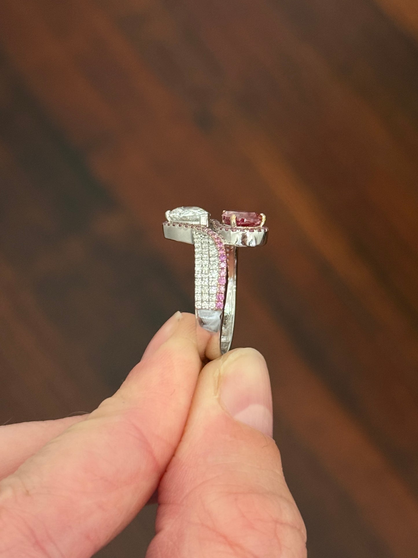 White gold pear shape and round pink and white lab diamond ring. Pink lab diamonds are set in rose gold.