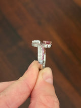 White gold pear shape and round pink and white lab diamond ring. Pink lab diamonds are set in rose gold.