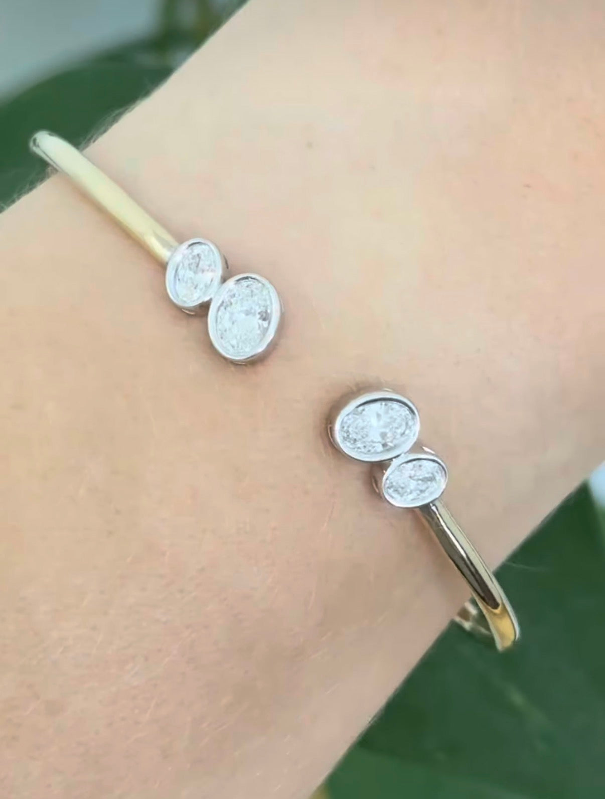 Yellow gold oval lab diamond bracelet. Lab diamond are bezel set in white gold