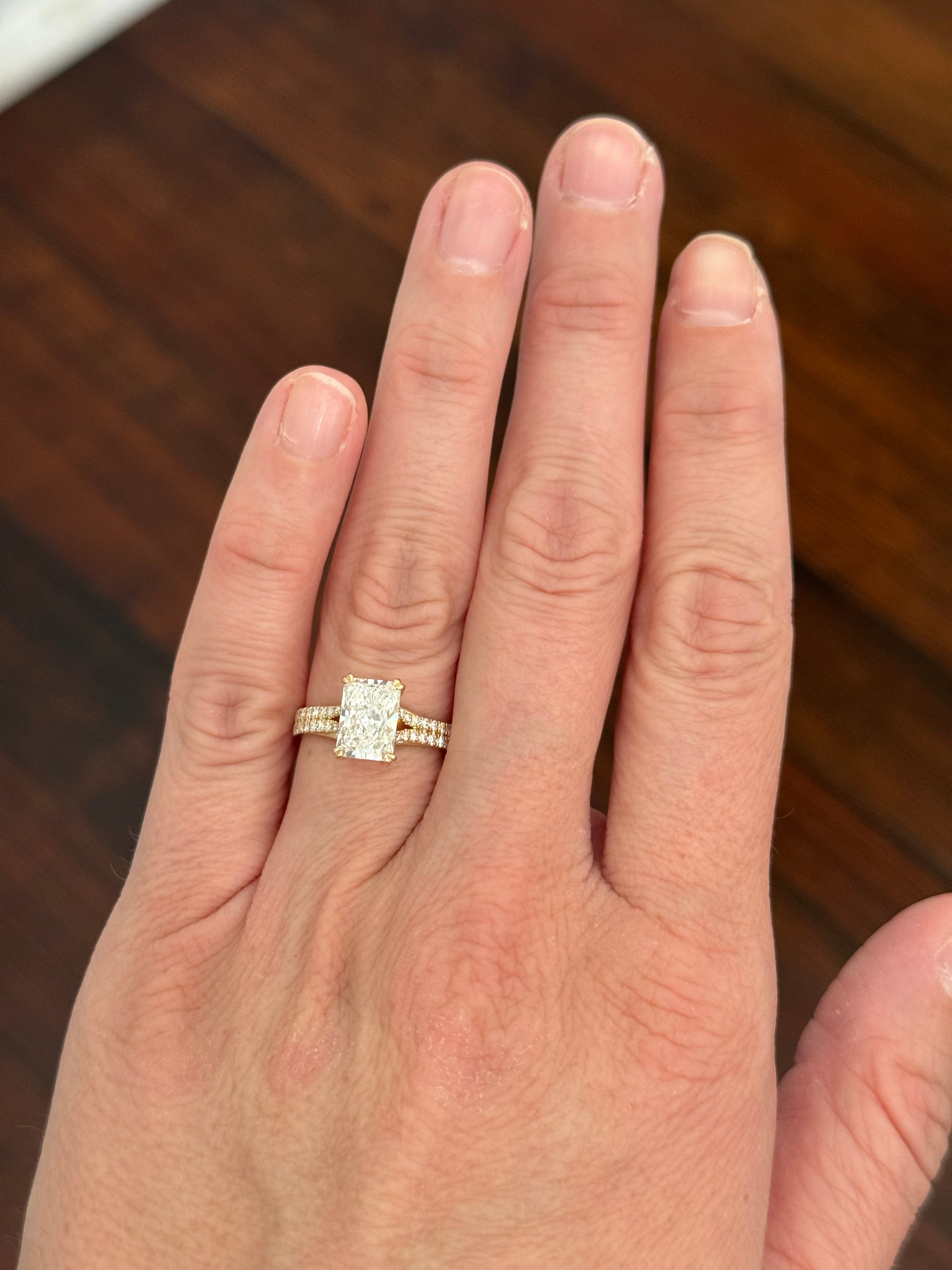 Yellow gold radiant and round lab diamond ring