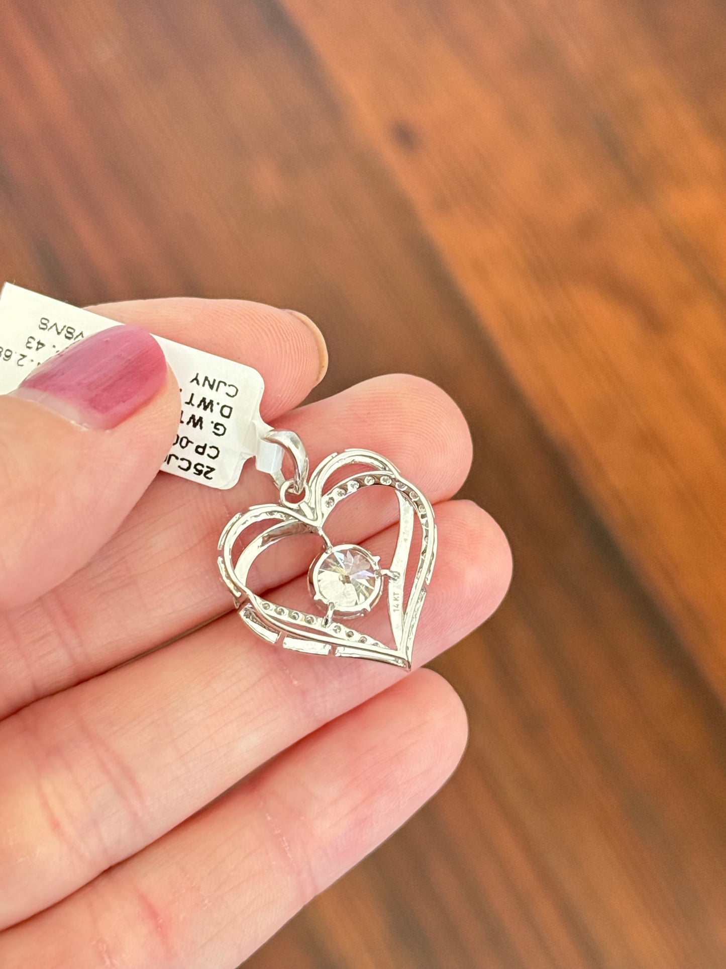 White gold heart pendant with round lab diamonds. Center stone is 7.0mm