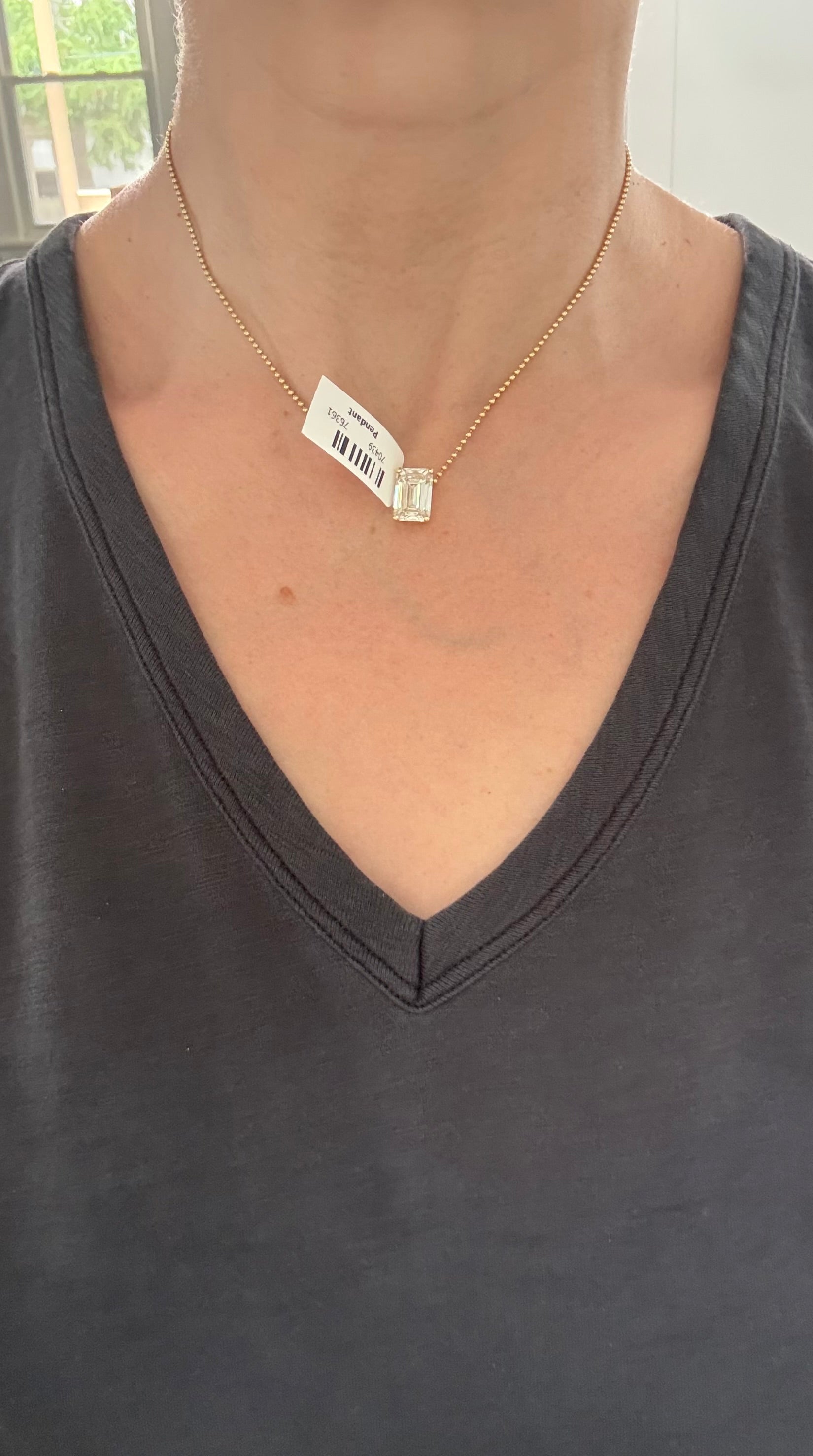 Yellow gold IGI certified 6.09ct emerald cut lab diamond pendant. Can be worn either east west or north south.