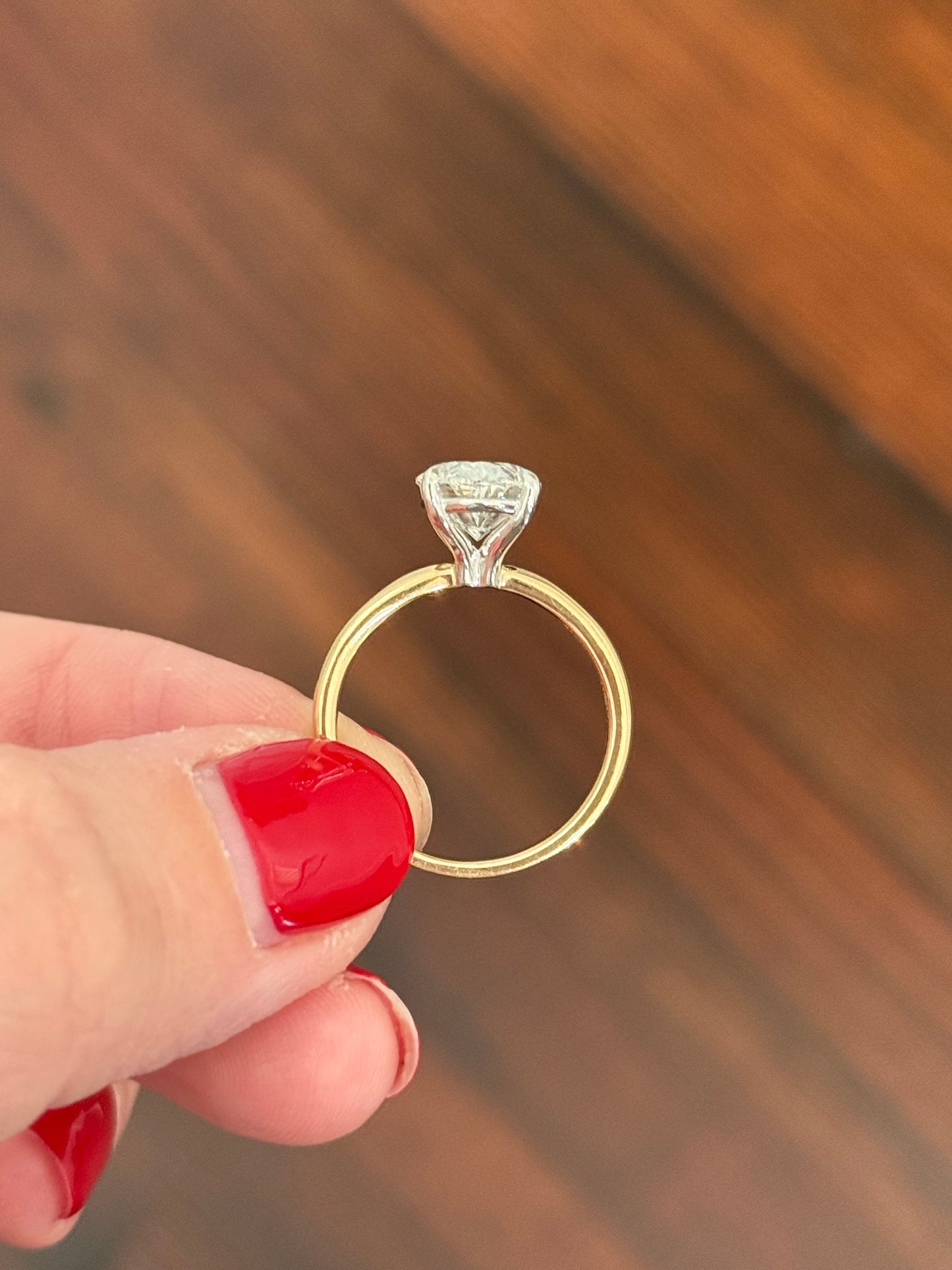 Yellow gold IGI certified oval lab diamond ring. Lab diamond is set in white gold