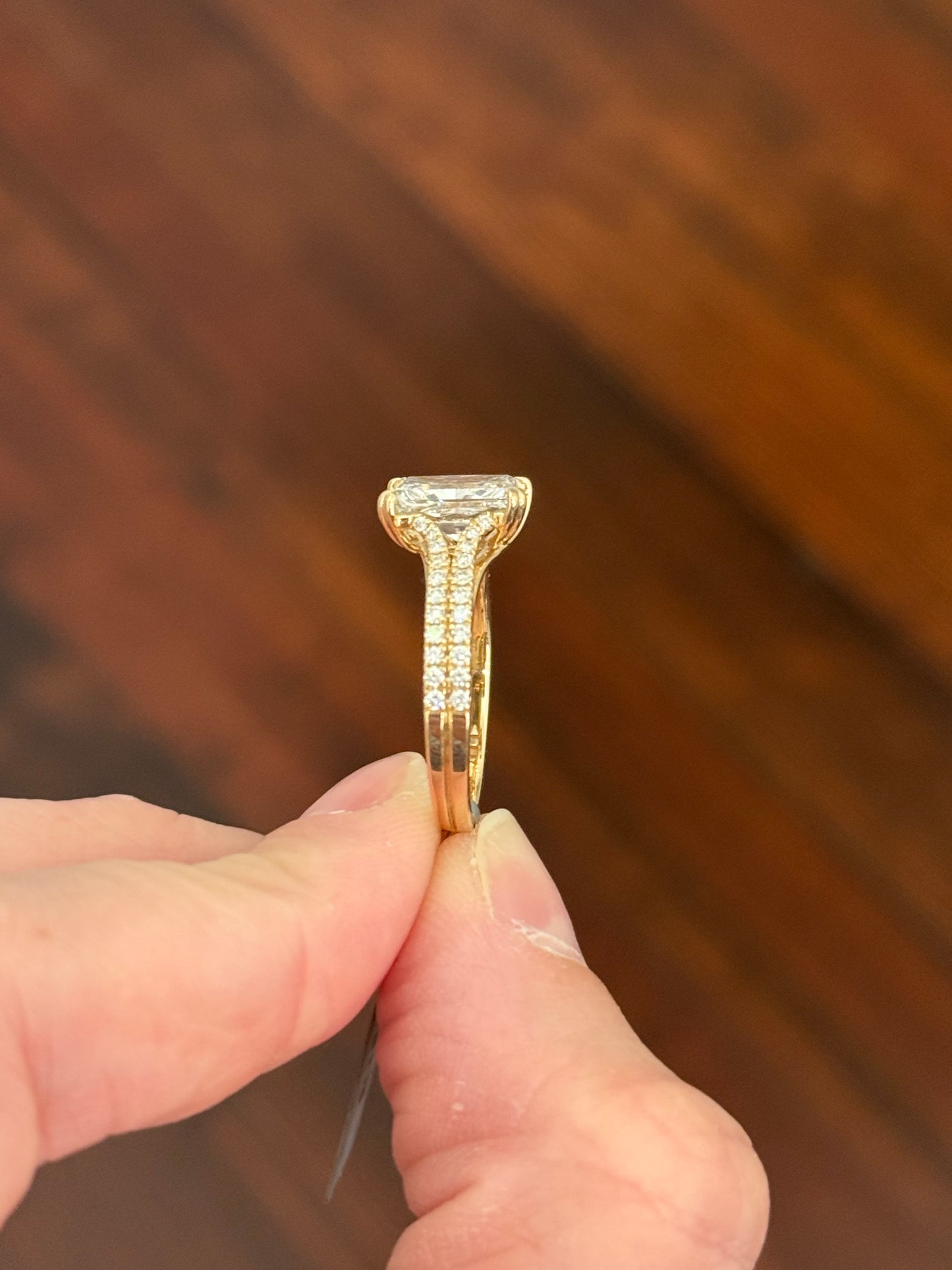 Yellow gold radiant and round lab diamond ring