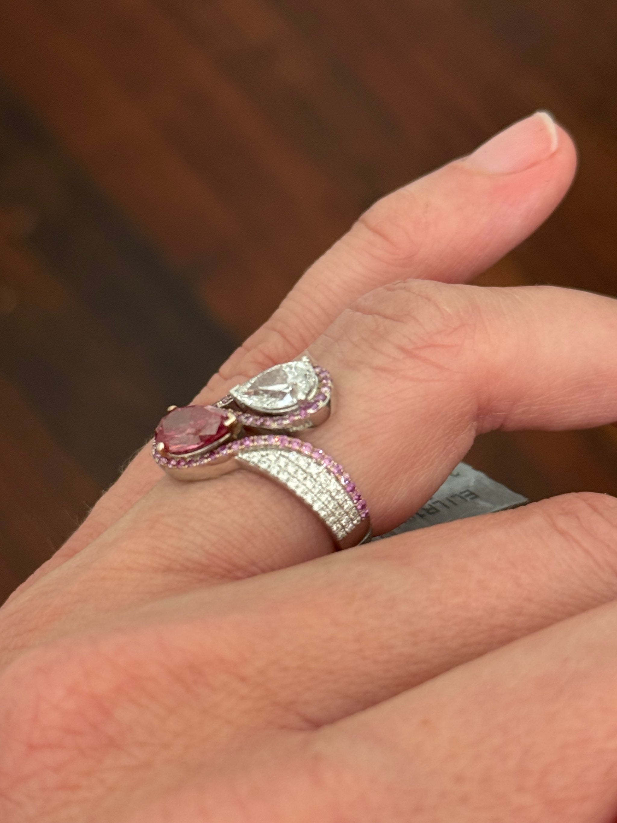 White gold pear shape and round pink and white lab diamond ring. Pink lab diamonds are set in rose gold.