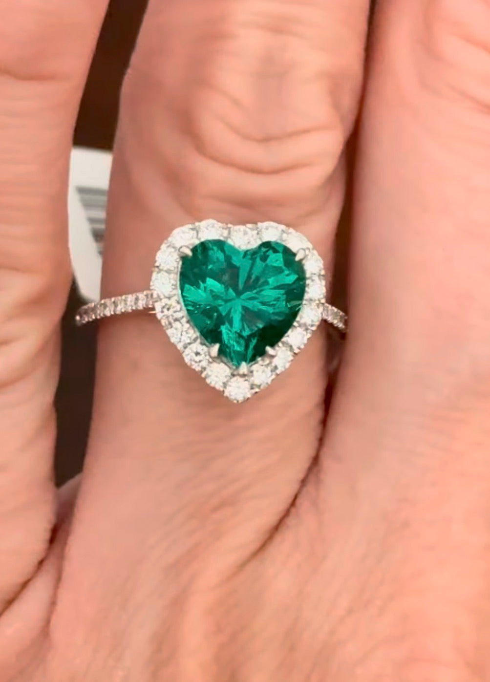 White gold heart shaped lab emerald and round lab diamond ring. Center stone is 2.32cts
