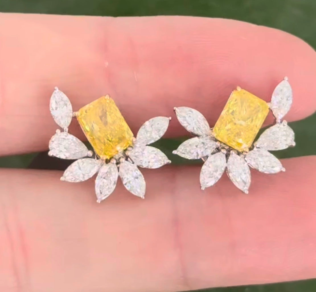 White gold radiant yellow lab diamond and pear shape and marquise white lab diamond earrings. Yellow lab diamond is set in yellow gold.