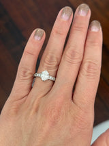 White gold oval and round lab diamond ring. Center stone is 1ct and approximately 8.5x5.5mm