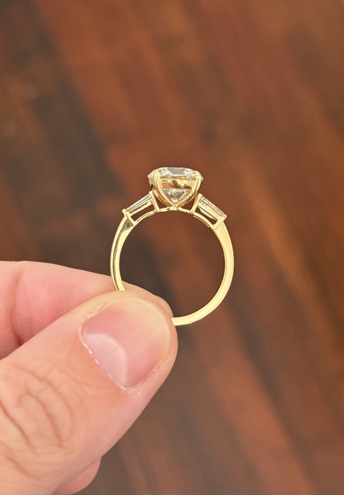 Yellow gold IGI certified 3.0ct round lab diamond and tapered baguette lab diamond ring. Round measures 9.18x5.71mm