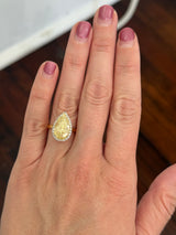 Yellow gold pear shape yellow lab diamond and white lab diamond ring