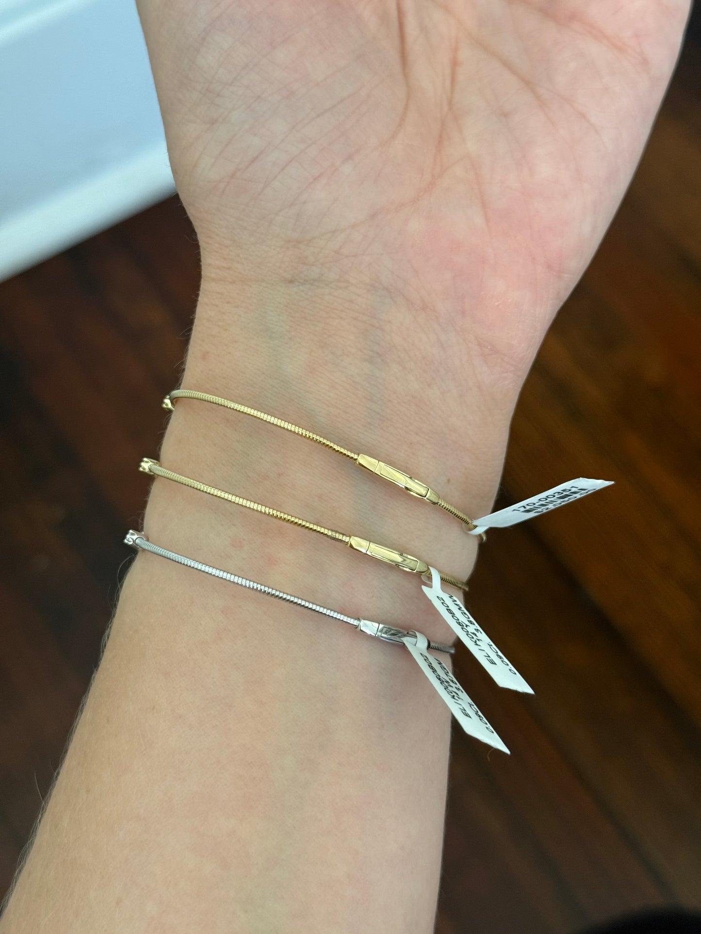Natural diamond flex bracelets available in yellow gold with sapphires, yellow gold with rubies, and white gold with emeralds