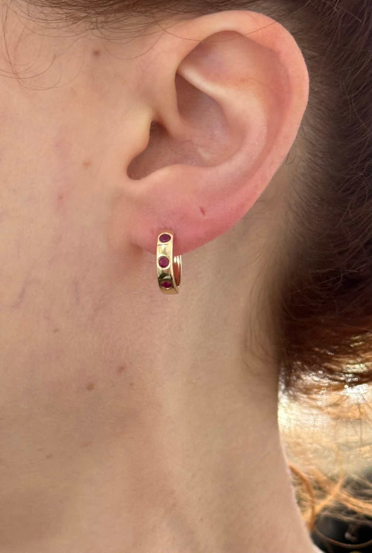 14.3mm hoop earrings available in yellow gold with rubies and white gold with emeralds