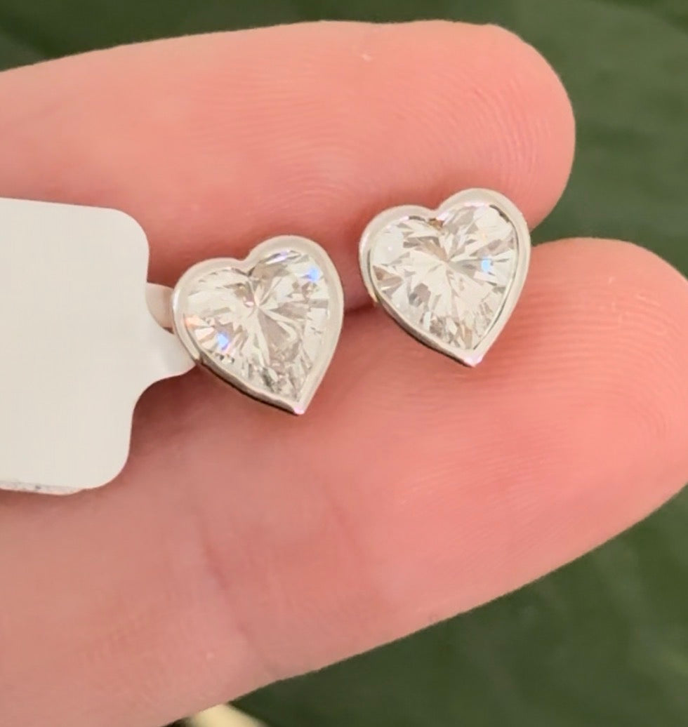 Yellow gold bezel set heart shape lab diamond stud earrings. Tops of bezel settings are white gold.