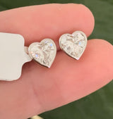 Yellow gold bezel set heart shape lab diamond stud earrings. Tops of bezel settings are white gold.