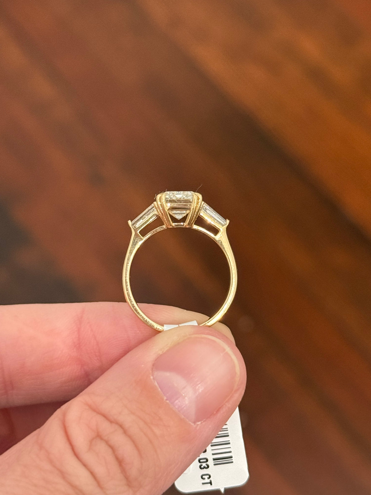 Yellow gold IGI certified emerald cut and tapered baguette lab diamond ring. Center stone is 3.03cts