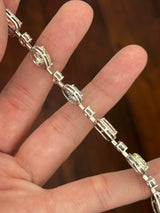 White gold mixed shape bracelet with radiant and marquise pink lab diamonds, oval blue lab diamonds, oval cushion and pear shaped yellow lab diamonds, and round white lab diamonds