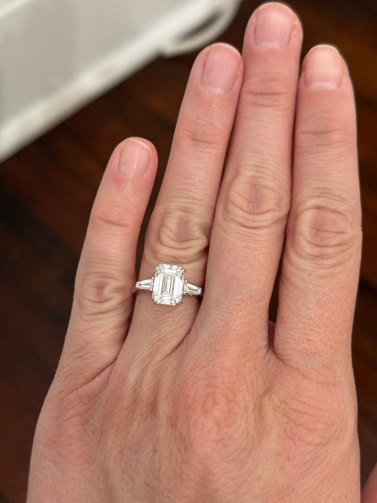 White gold IGI certified emerald cut and tapered baguette lab diamond ring. Center stone is 3.06cts