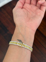 Yellow gold 17.44ct radiant yellow lab diamond and round white lab diamond bracelet. White diamond’s prongs are white gold.