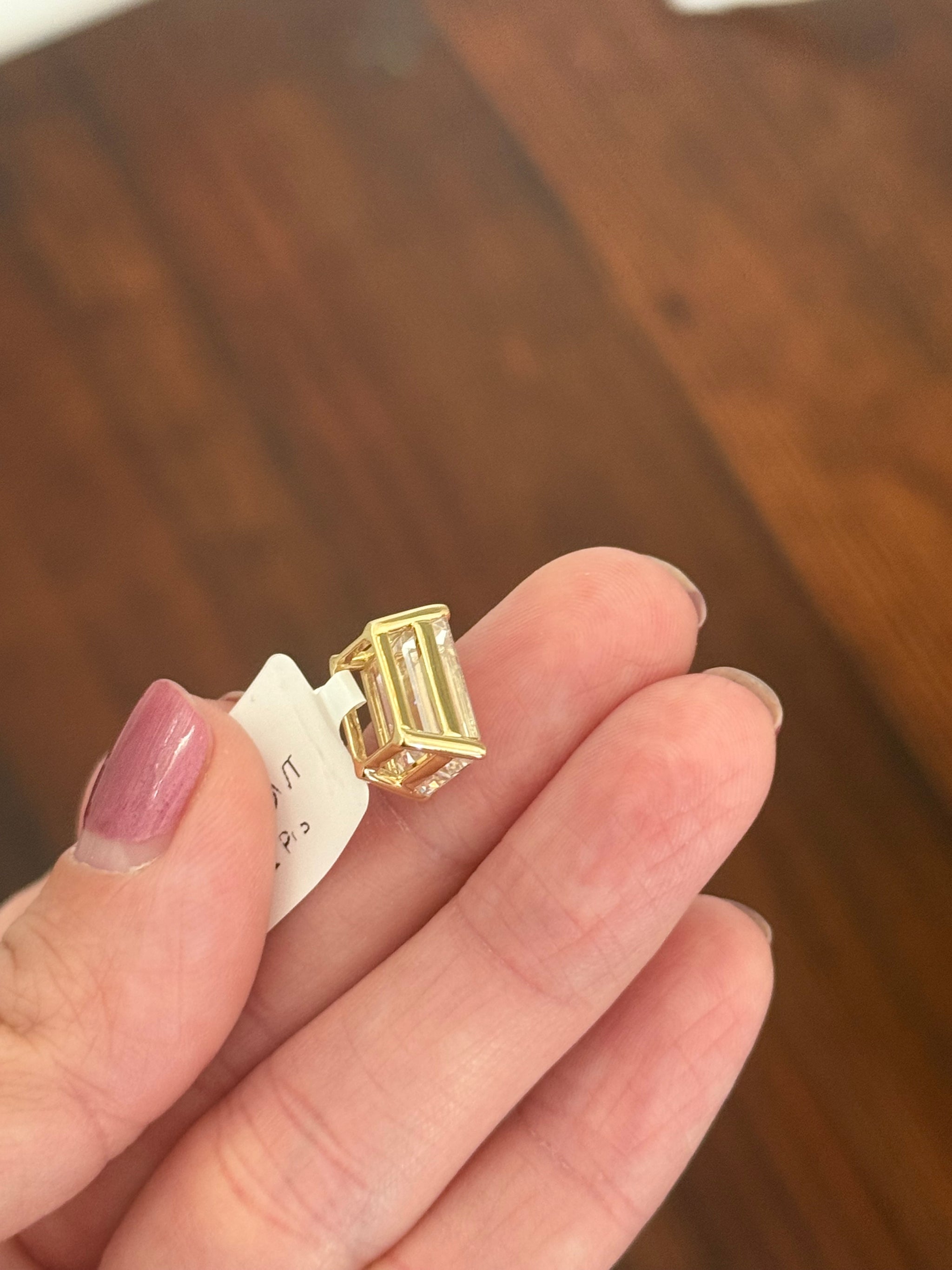 Yellow gold IGI certified 6.09ct emerald cut lab diamond pendant. Can be worn either east west or north south.