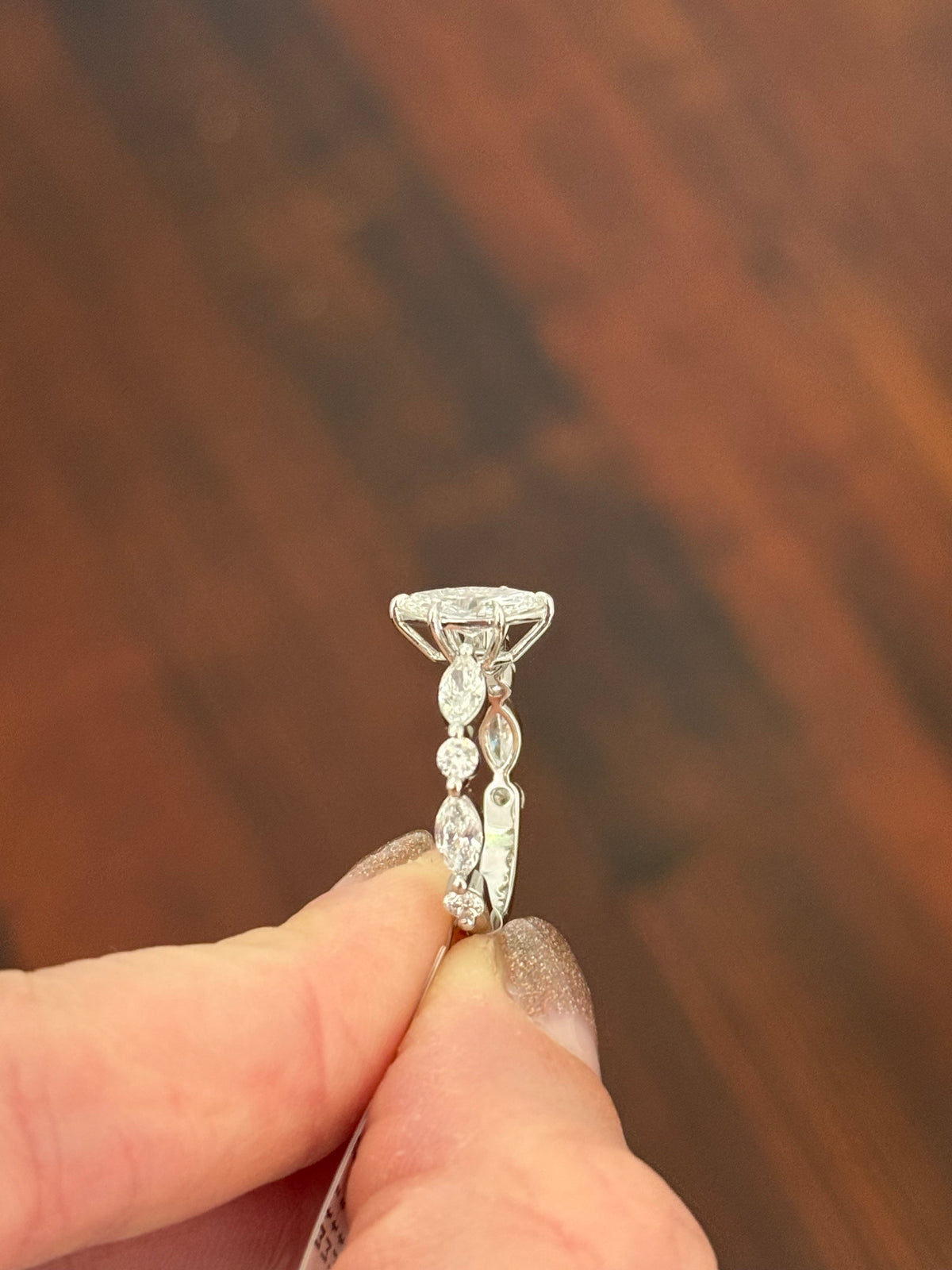 White gold marquise and round lab diamond ring. Center stone is 0.9cts and approximately 10x4.5mn