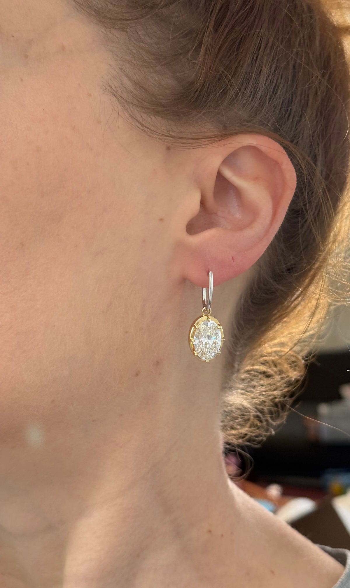 Oval lab diamond latch back earrings. Lab diamonds are set in yellow gold and earrings are white gold.