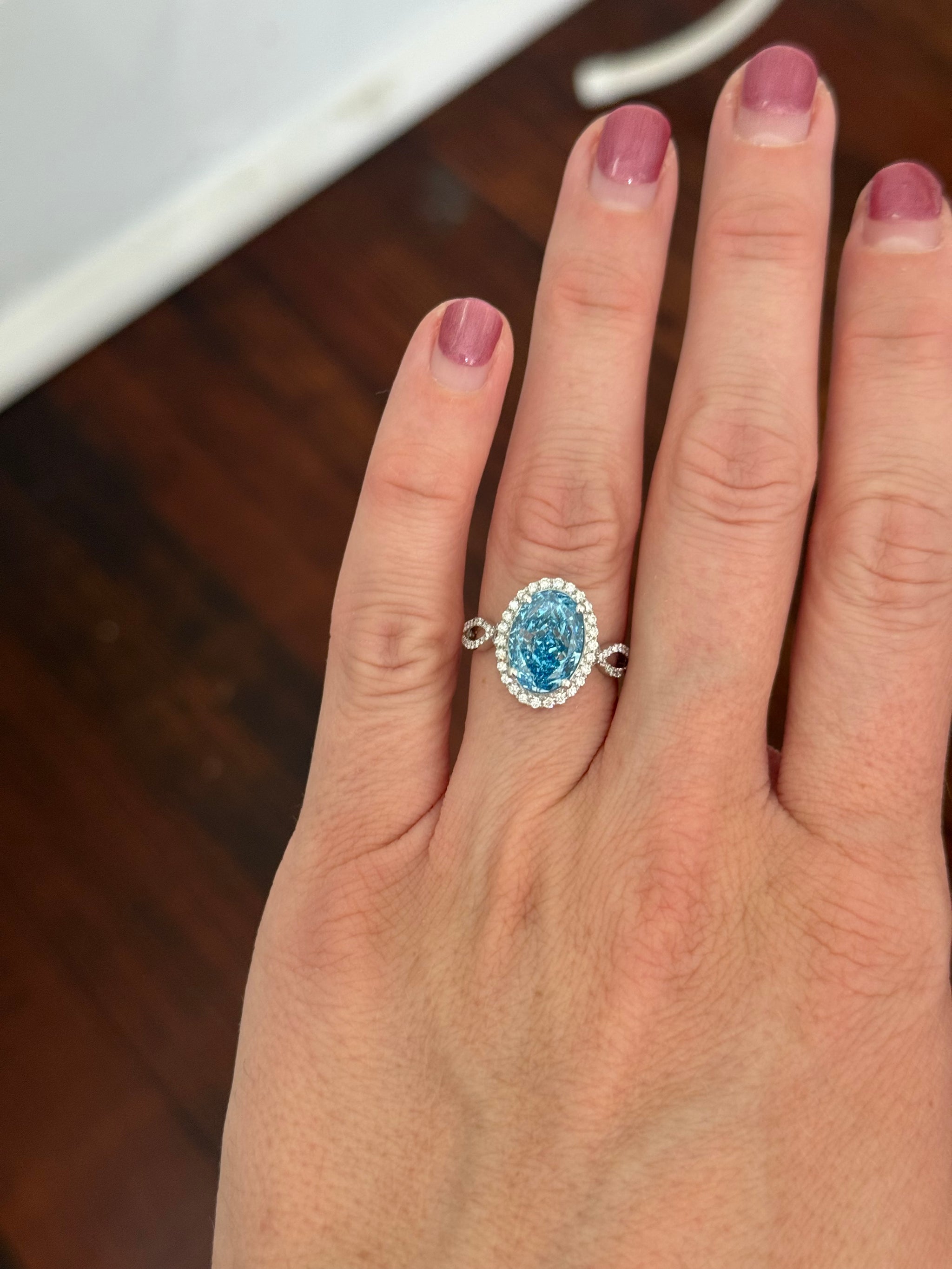 White gold oval blue lab diamond and white lab diamond ring