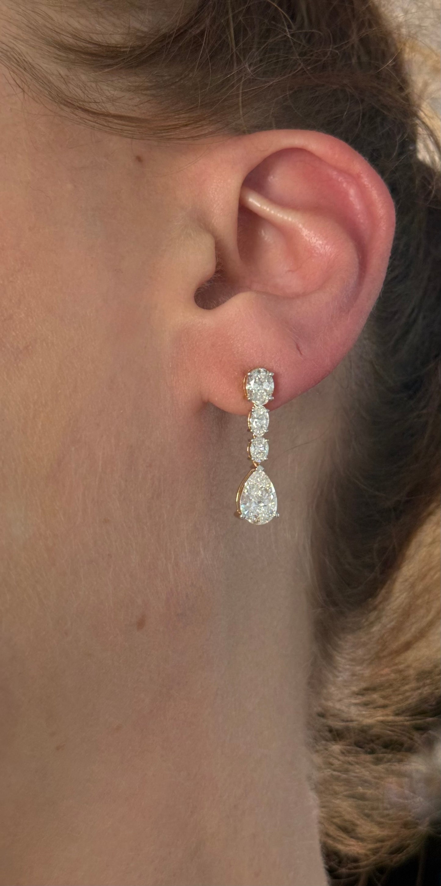 Yellow gold pear shape and oval lab diamond earrings. Prongs are white gold.