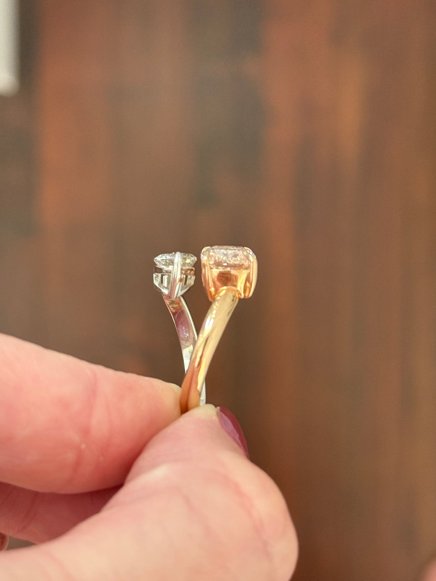 Rose and white gold cushion pink lab diamond and white marquise lab diamond toi et moi ring. Pink lab diamond is set in rose gold and white lab diamond is set in white gold.