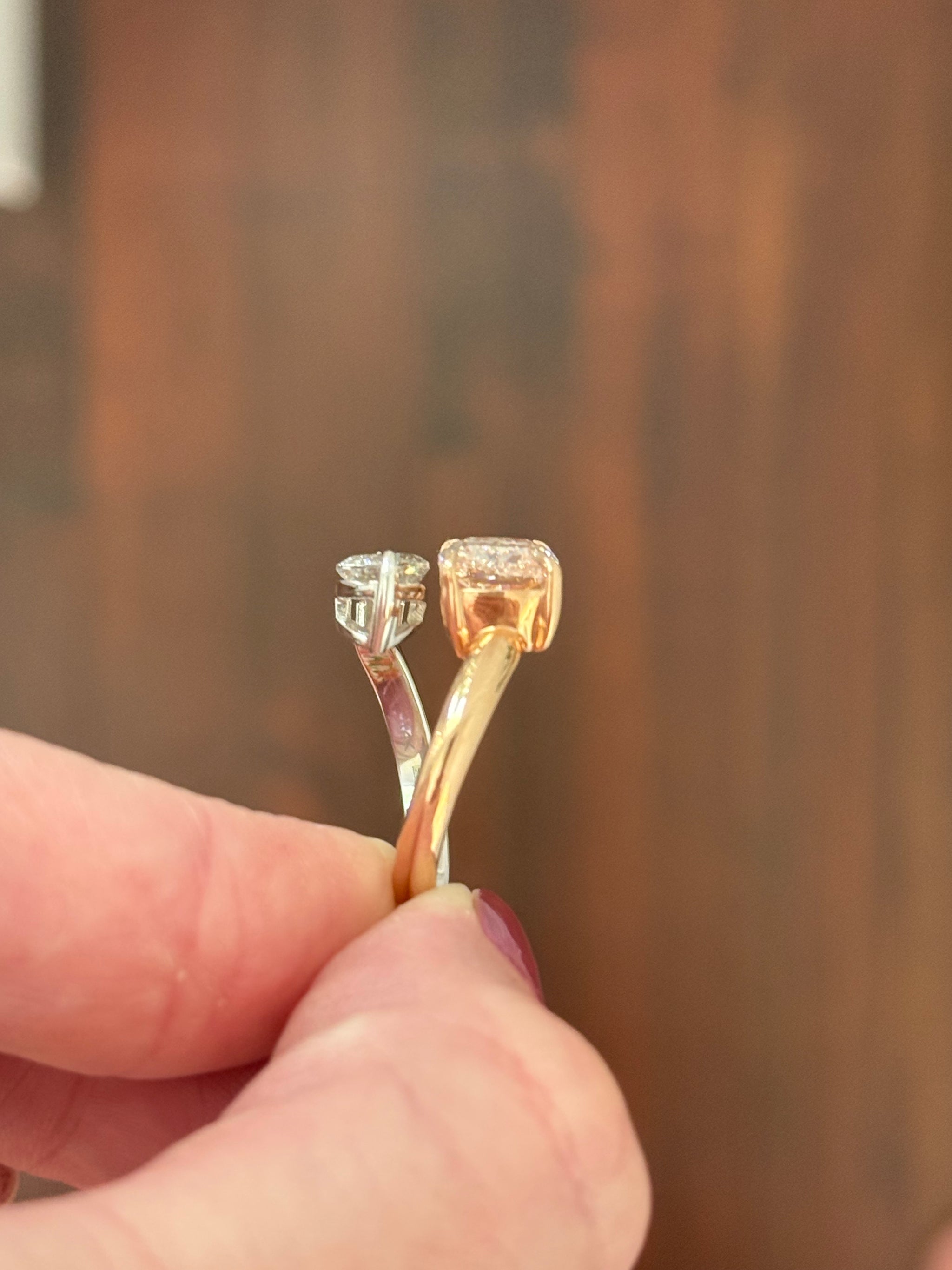 Rose and white gold cushion pink lab diamond and white marquise lab diamond toi et moi ring. Pink lab diamond is set in rose gold and white lab diamond is set in white gold.
