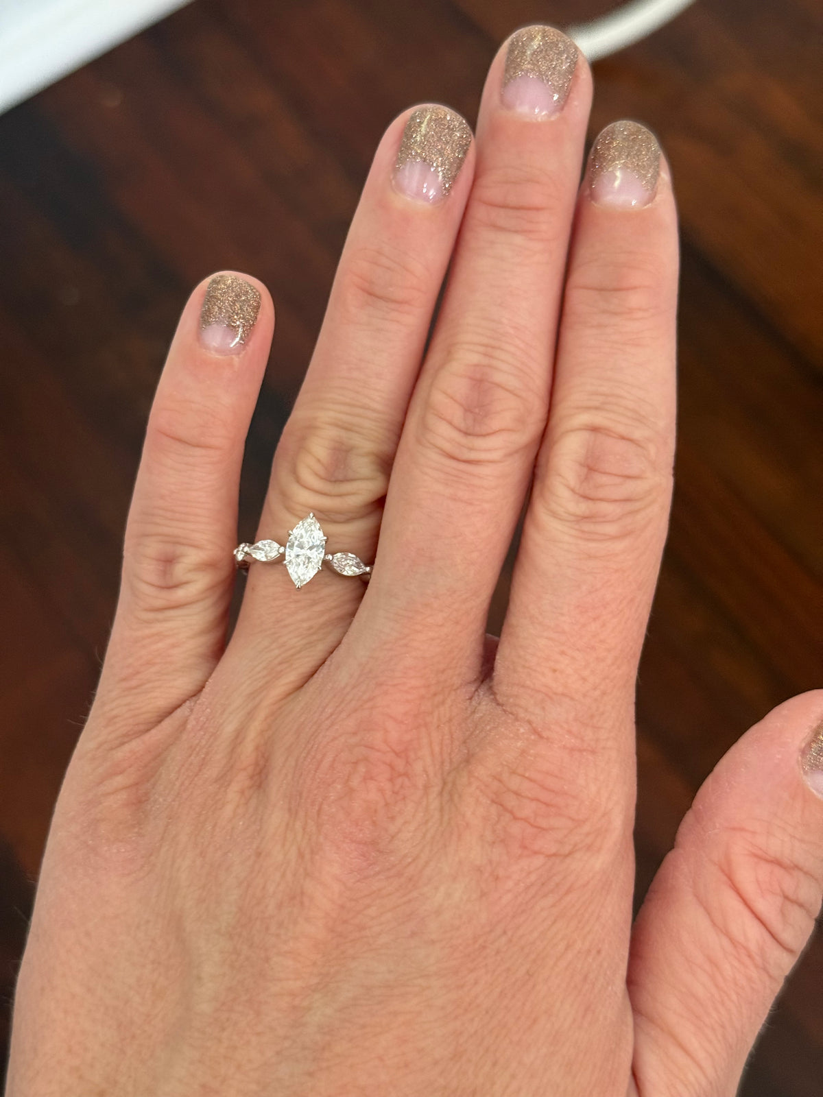 White gold marquise and round lab diamond ring. Center stone is 0.9cts and approximately 10x4.5mn