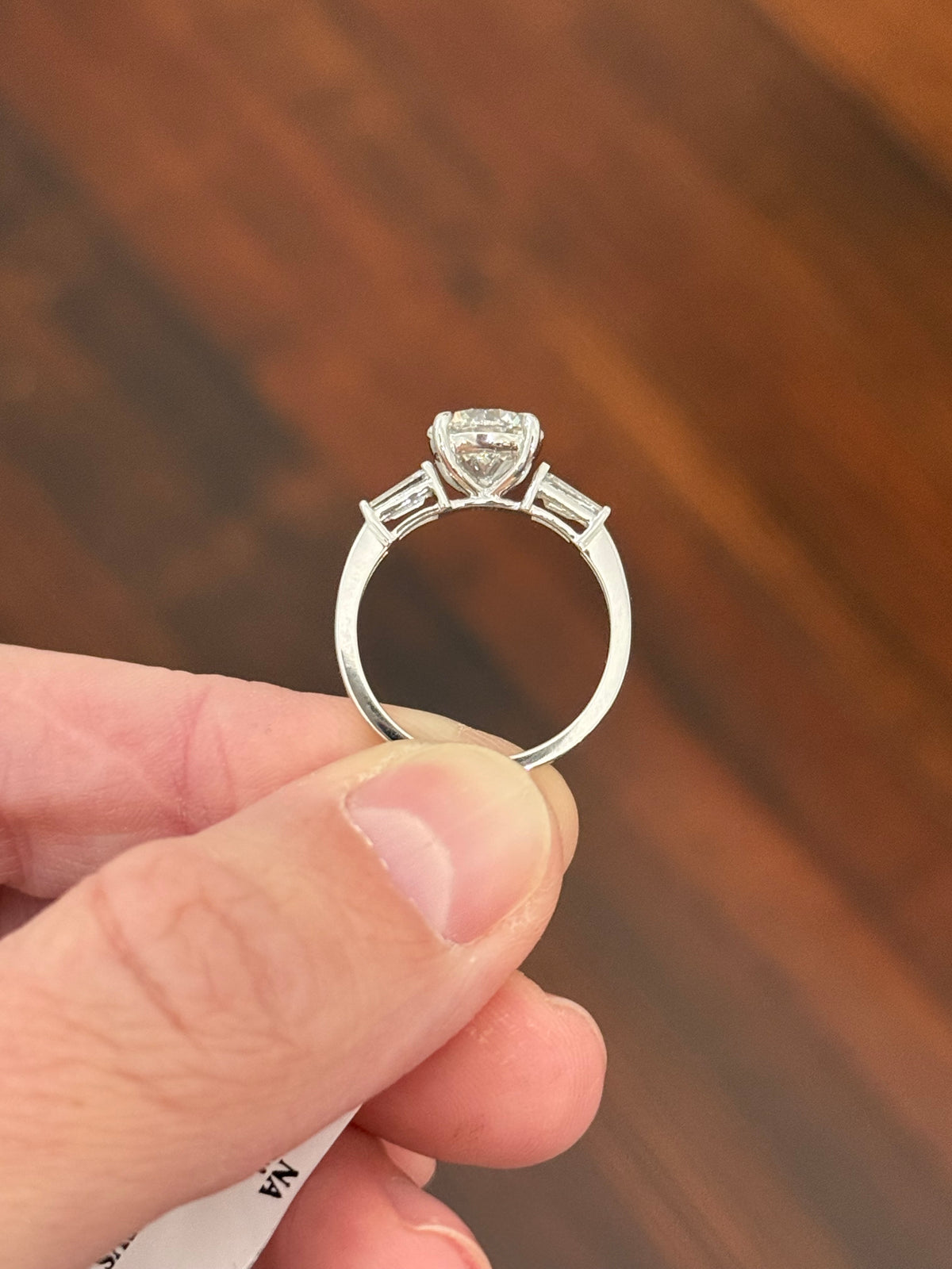 White gold IGI certified 2.04ct round lab diamond and tapered baguette lab diamond ring. Round measures 8.08x5.04mm