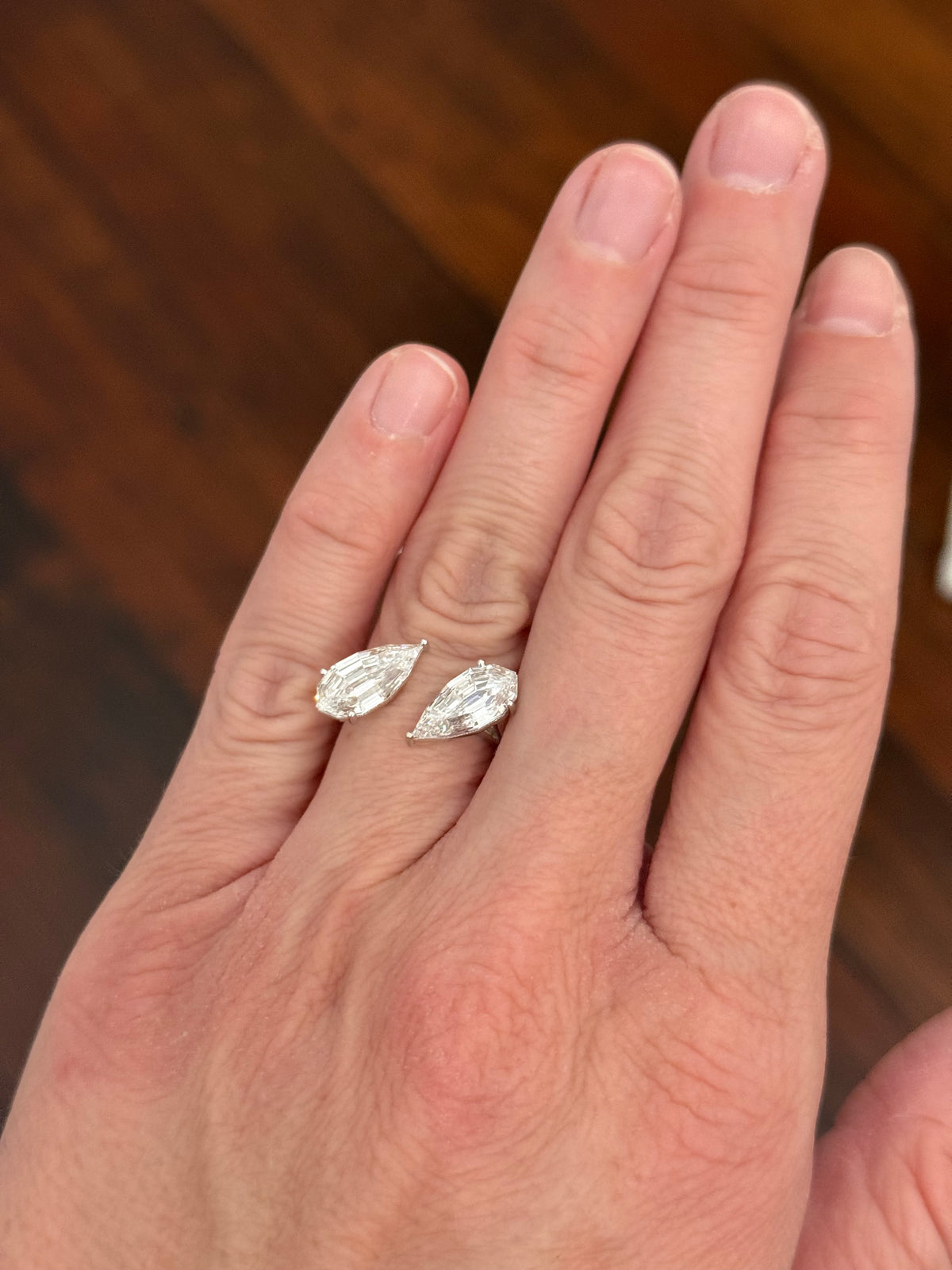 White gold 4.38ct step cut pear lab diamond bypass ring. Each measures 12.78x6.10mm