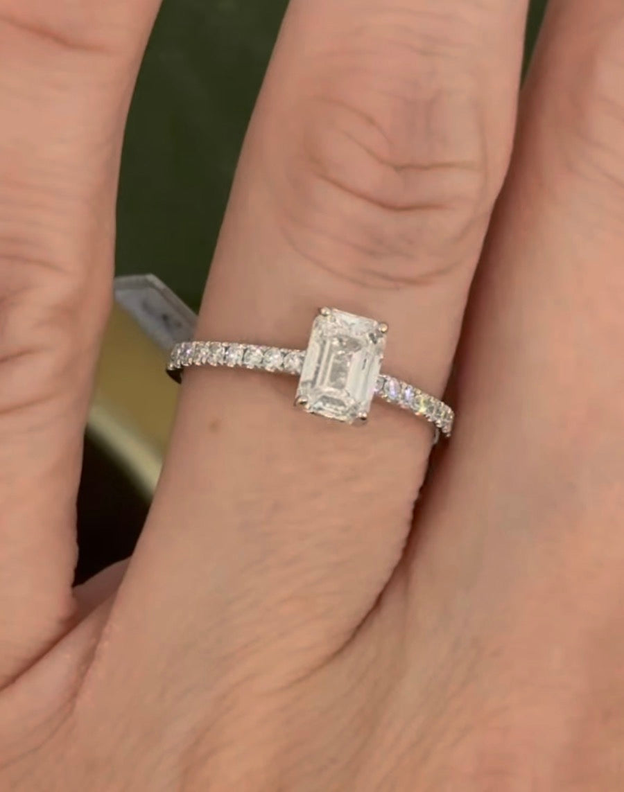 White gold 1.35ct emerald cut lab diamond ring. Center stone is 1.09cts and measures 6.7x4.3mm