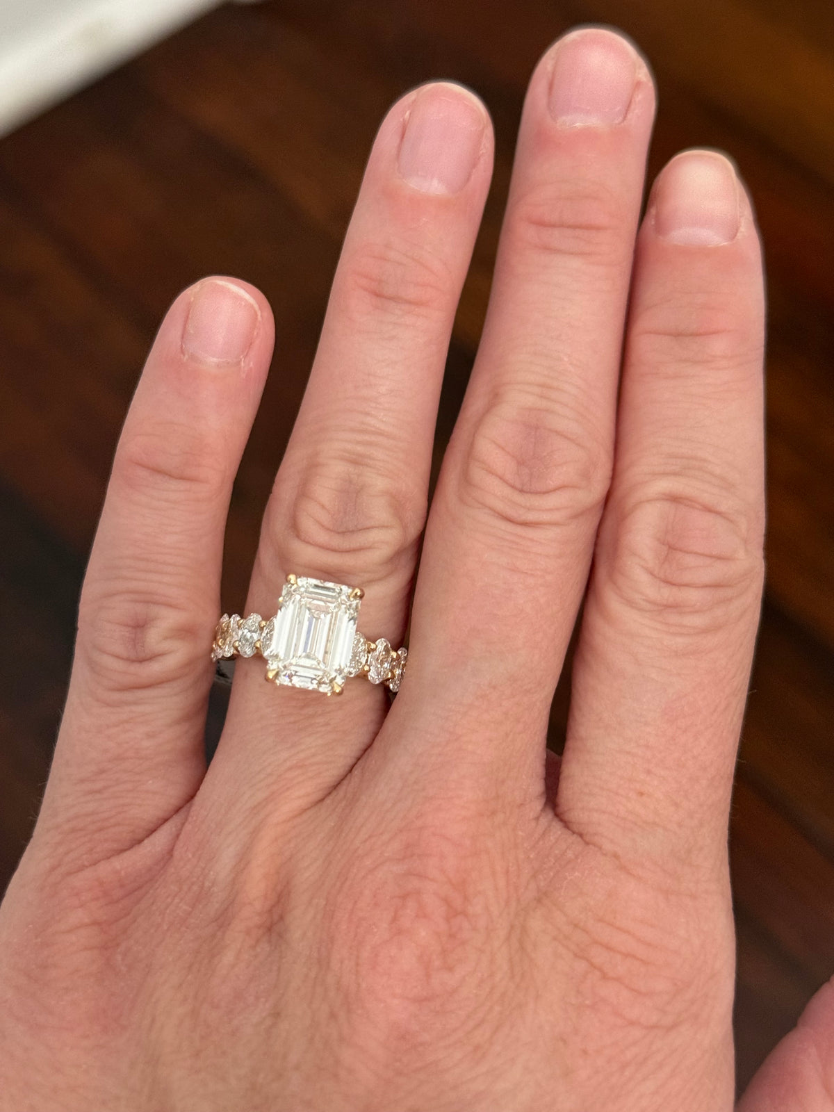 IGI certified emerald cut and oval and round lab diamond ring. Center stone is 5.05cts